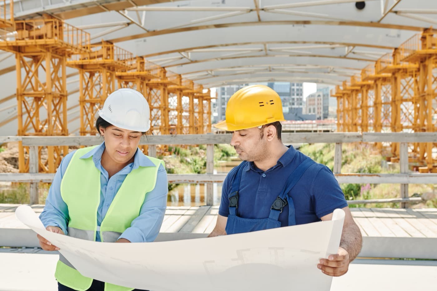 Construction team reviewing building plans on site